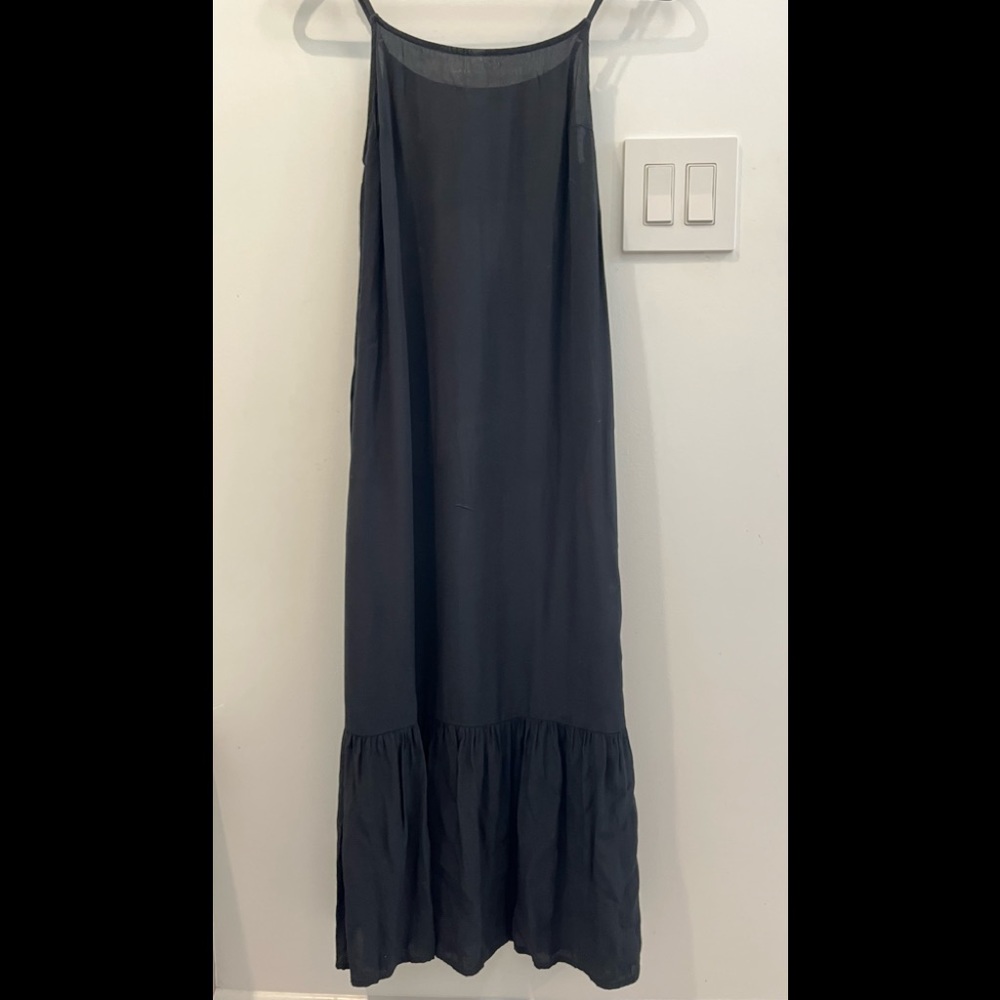 Black sleeveless dress with a ruffle on bottom